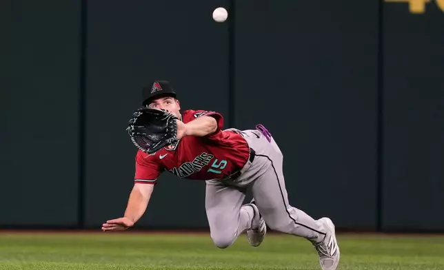 Arizona Diamondbacks center fielder Ryan Waldschmidt makes a diving catch on a Texas Rangers' Jake Burger fly out in the fifth inning of a baseball game Monday, May 11, 2026, in Arlington, Texas. (AP Photo/Tony Gutierrez)
