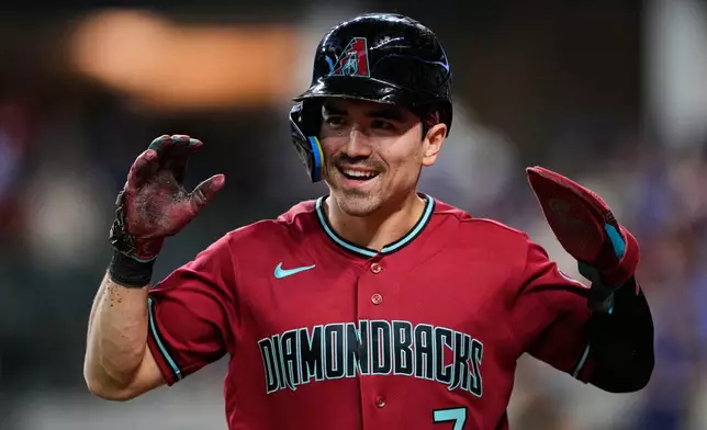 Arizona Diamondbacks' Corbin Carroll celebrates after scoring on a Geraldo Perdomo double in the first inning of a baseball game against the Texas Rangers Monday, May 11, 2026, in Arlington, Texas. (AP Photo/Tony Gutierrez)