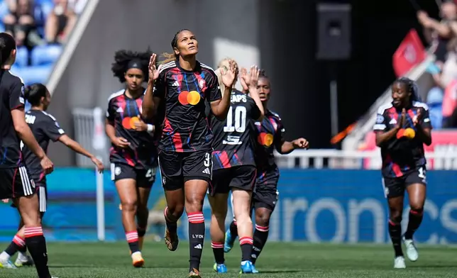 Lyonnes' Wendie Renard, center, celebrates after scoring the opening goal from the penalty spot during the Women's Champions League semifinal, second leg, soccer match between OL Lyonnes and Arsenal, in Decines, outside Lyon, France, Saturday, May 2, 2026. (AP Photo/Laurent Cipriani)
