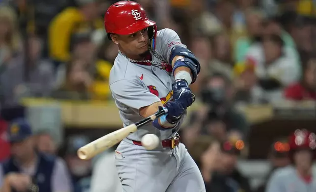 St. Louis Cardinals' Masyn Winn hits an RBI triple during the seventh inning of a baseball game against the San Diego Padres Thursday, May 7, 2026, in San Diego. (AP Photo/Gregory Bull)