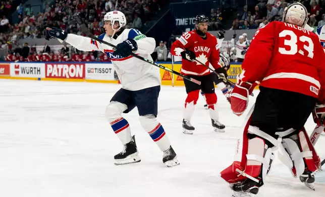 Norway's Noah Steen, left, celebrates after scoring during the 2026 IIHF Men's Ice Hockey World Championship preliminary round group B game between Canada and Norway, in Fribourg, Switzerland, Thursday, May 21, 2026. (Anthony Anex/Keystone via AP)