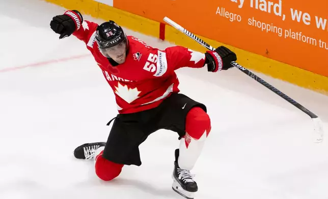 Canada's Mark Scheifele celebrates the winning goal in overtime of the 2026 IIHF Men's Ice Hockey World Championship preliminary round group B game between Canada and Norway, in Fribourg, Switzerland, Thursday, May 21, 2026. (Anthony Anex/Keystone via AP)
