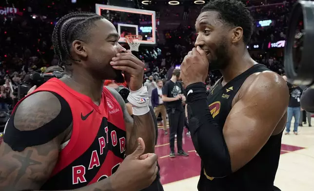 Toronto Raptors guard Jamal Shead, left, and Cleveland Cavaliers guard Donovan Mitchell, right, talk after the Cavaliers defeated the Raptors in Game 7 of a first-round NBA basketball playoffs series in Cleveland, Sunday, May 3, 2026. (AP Photo/Sue Ogrocki)