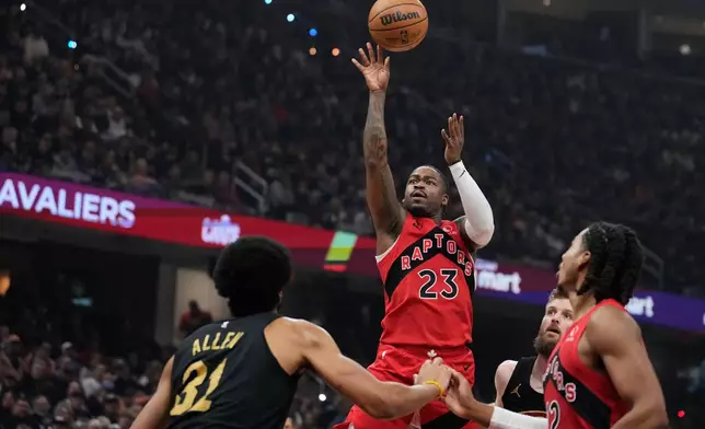 Toronto Raptors guard Jamal Shead (23) shoots over Cleveland Cavaliers center Jarrett Allen (31) in the first half in Game 7 of a first-round NBA basketball playoffs series in Cleveland, Sunday, May 3, 2026. (AP Photo/Sue Ogrocki)