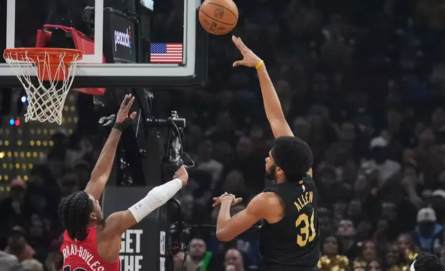 Cleveland Cavaliers center Jarrett Allen (31) shoots next to Toronto Raptors forward Collin Murray-Boyles (12) in the first half in Game 7 of a first-round NBA basketball playoffs series in Cleveland, Sunday, May 3, 2026. (AP Photo/Sue Ogrocki)