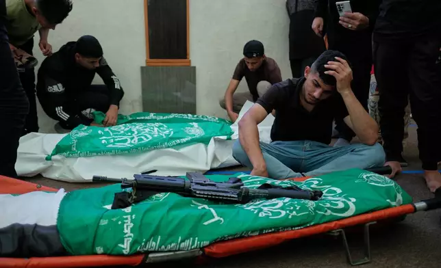 Palestinians mourn over the bodies of Hamas militant Imad Isleim, foreground, his wife and daughter, who were killed in an Israeli military strike, during their funeral at Al-Shafi'i Mosque in Gaza City, Thursday, May 28, 2026. (AP Photo/Jehad Alshrafi) CORRECTION: Corrects surname from al-Salem to Isleim