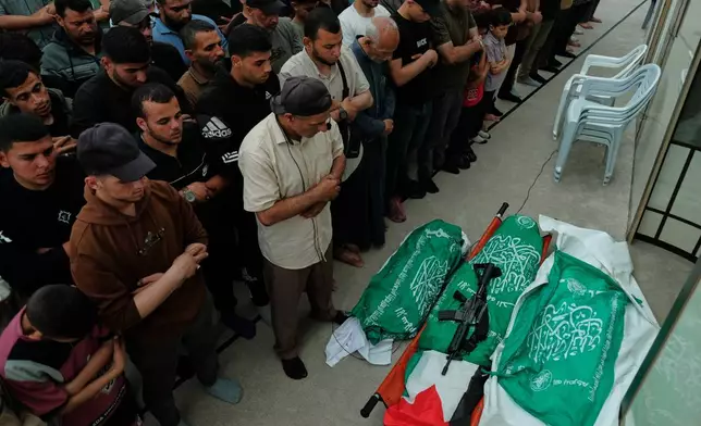 Palestinians pray over the bodies of Hamas militant Imad al-Salem, center, his wife and daughter, who were killed in an Israeli military strike, during their funeral at Al-Shafi'i Mosque in Gaza City, Thursday, May 28, 2026. (AP Photo/Jehad Alshrafi)