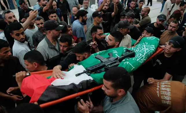 Palestinians carry the body of Hamas militant Imad al-Salem, who was killed in an Israeli military strike, during his funeral at Al-Shafi'i Mosque in Gaza City, Thursday, May 28, 2026. (AP Photo/Jehad Alshrafi)