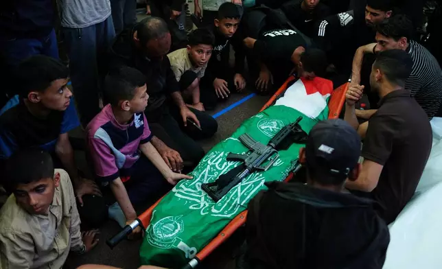 Palestinians mourn over the body of Hamas militant Imad al-Salem, who was killed in an Israeli military strike, during his funeral at Al-Shafi'i Mosque in Gaza City, Thursday, May 28, 2026. (AP Photo/Jehad Alshrafi)