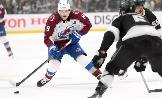 Colorado Avalanche's Cale Makar (8) brings the puck across the blue line against Los Angeles Kings during the first period of Game 4 in the first round of an NHL hockey Stanley Cup playoff series Sunday, April 26, 2026, in Los Angeles. (AP Photo/Scott Strazzante)