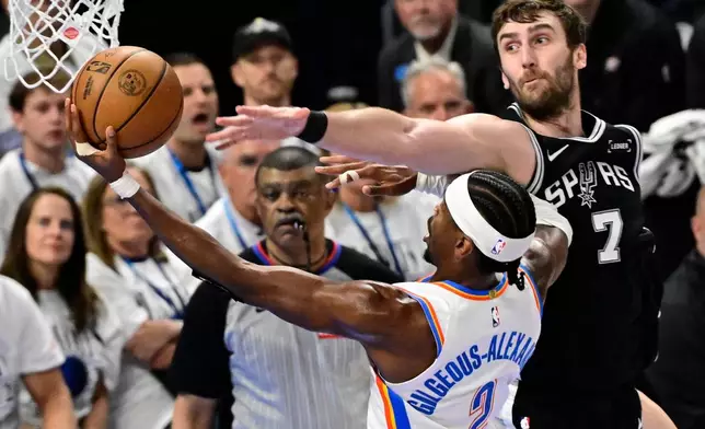 Oklahoma City Thunder guard Shai Gilgeous-Alexander (2) goes to the basket aginst San Antonio Spurs center Luke Kornet (7) in the second half of Game 5 in the Western Conference finals NBA basketball playoffs series, Tuesday, May 26, 2026, in Oklahoma City. (AP Photo/Gerald Leong)