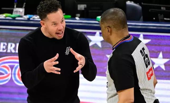 San Antonio Spurs head coach Mitch Johnson speaks to referee Tony Brothers in the second half of Game 5 in the Western Conference finals NBA basketball playoffs series against the Oklahoma City Thunder, Tuesday, May 26, 2026, in Oklahoma City. (AP Photo/Gerald Leong)