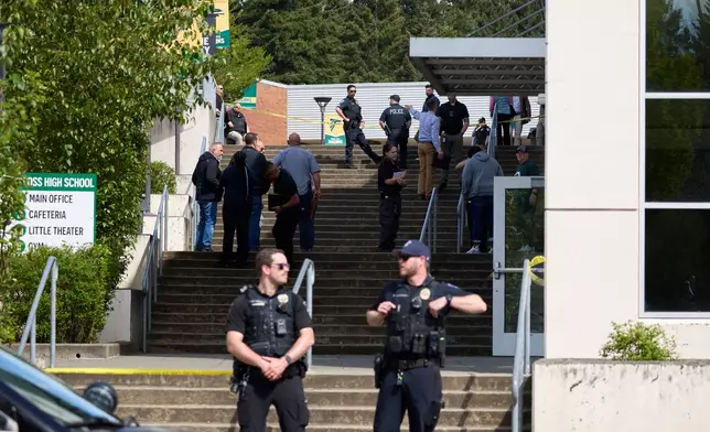 Tacoma Police officers investigate after multiple people were injured in a stabbing at Foss High School, Thursday, April 30, 2026, in Tacoma, Wash. (AP Photo/John Froschauer)