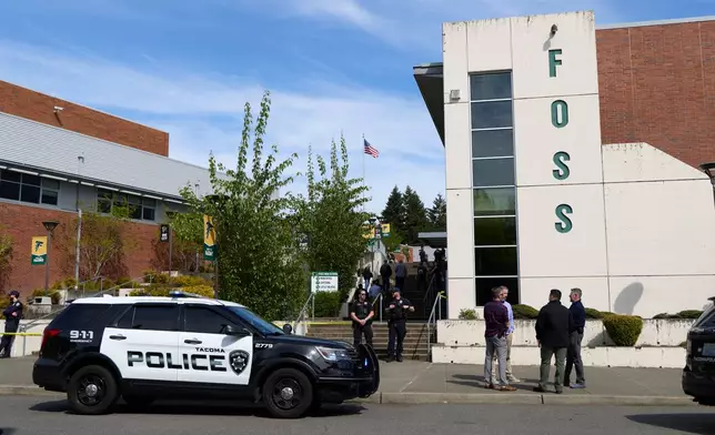 Tacoma Police officers investigate after multiple people were injured in a stabbing at Foss High School, Thursday, April 30, 2026, in Tacoma, Wash. (AP Photo/John Froschauer)