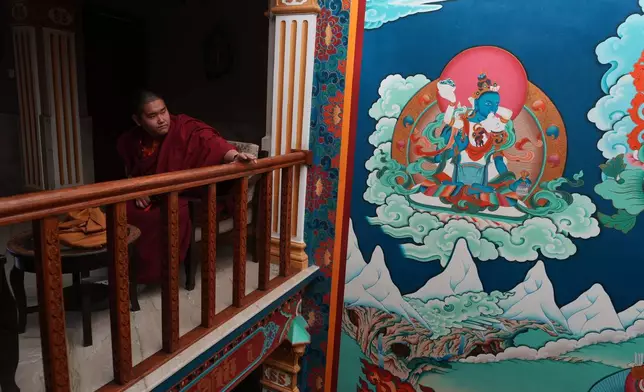 U.S.-born Buddhist lama Jalue Dorje pauses outside of his hotel room before he walks to nearby Shechen Monastery for a series of rituals and teachings in Kathmandu, Nepal, on Monday, April 6, 2026. (AP Photo/Luis Andres Henao)