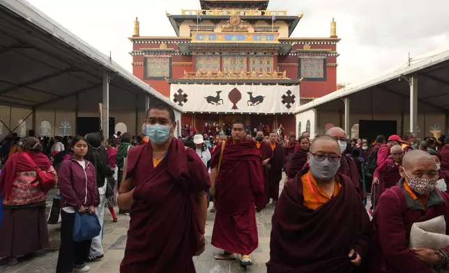 U.S.-born Buddhist lama Jalue Dorje walks out of Shechen Monastery after a day of rituals and teachings in Kathmandu, Nepal, on Thursday, April 9, 2026. (AP Photo/Luis Andres Henao)