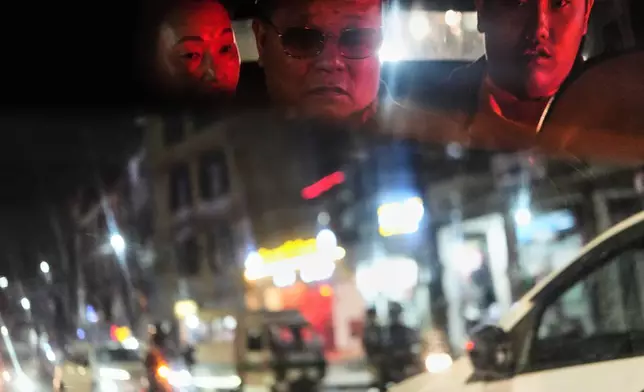 Jalue Dorje, right, and his parents, Dorje Tsegyal, center, Dechen Wangmo, ride a taxi in Kathmandu, Nepal, on Wednesday, April 8, 2026. (AP Photo/Luis Andres Henao)