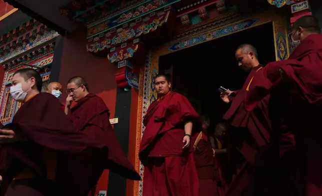 U.S.-born Buddhist lama Jalue Dorje walks out of a prayer hall during a series of rituals and prayers bestowed by the spiritual leader of Shechen Monastery in Kathmandu, Nepal, on Sunday, April 12, 2026. (AP Photo/Luis Andres Henao)