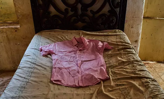 A shirt belonging to Suleiman Abdelsaid, who went missing in 2024 at age 18, is displayed on a bed at his family home in Omdurman, Sudan, Tuesday, April 21, 2026. (AP Photo/Bernat Armangue)
