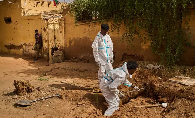 Staff from Sudan's Forensic Medicine Corporation exhume the body of Mohammed Alsawi, 73, who was killed in 2023 by the paramilitary Rapid Support Forces, or RSF, in Omdurman, Sudan, Monday, April 20, 2026. (AP Photo/Bernat Armangue)