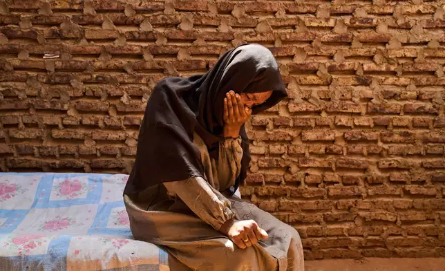 Azaher Abdallah, who has been searching for her husband, Fahani Al Fateh, for over a year, becomes emotional during an interview with The Associated Press in Omdurman, Sudan, Sunday, April 19, 2026. (AP Photo/Bernat Armangue)