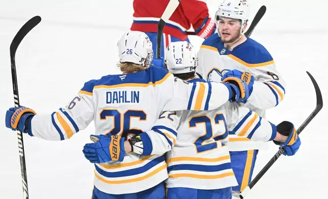 Buffalo Sabres' Rasmus Dahlin (26) celebrates after his goal with teammates Jack Quinn (22) and Zach Benson (6) during the second period of Game 3 in a second-round NHL hockey Stanley Cup playoff series in Montreal, Sunday, May 10, 2026. (Graham Hughes/The Canadian Press via AP)