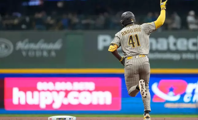 San Diego Padres' Miguel Andujar gestures as he rounds the bases after hitting a solo home run during the sixth inning of a baseball game against the Milwaukee Brewers, Tuesday, May 12, 2026, in Milwaukee. (AP Photo/Aaron Gash)