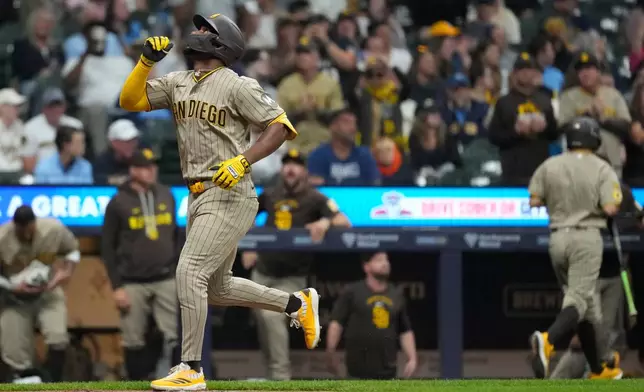 San Diego Padres' Miguel Andujar gestures as he rounds the bases after hitting a solo home run during the sixth inning of a baseball game against the Milwaukee Brewers, Tuesday, May 12, 2026, in Milwaukee. (AP Photo/Aaron Gash)
