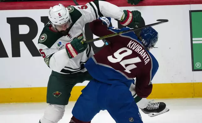 Minnesota Wild defenseman Jake Middleton, left, checks Colorado Avalanche left wing Joel Kiviranta in the first period of Game 5 of an NHL Stanley Cup hockey second-round playoff series, Wednesday, May 13, 2026, in Denver. (AP Photo/David Zalubowski)