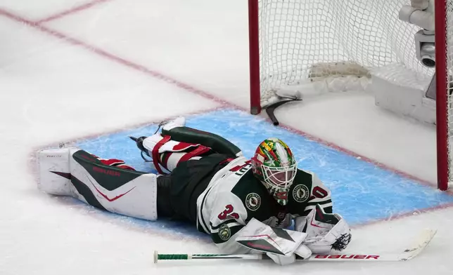 Minnesota Wild goaltender Jesper Wallstedt reacts after allowing the winning goal on a shot by Colorado Avalanche defenseman Brett Kulak in overtime of Game 5 of an NHL Stanley Cup hockey second-round playoff series Wednesday, May 13, 2026, in Denver. (AP Photo/David Zalubowski)