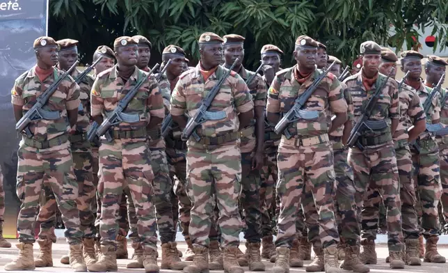 Soldiers wait for the start of the funeral for Mali's former defense minister Sadio Camara at the Military Engineering Parade Ground in Bamako, Mali, Thursday, April 30, 2026. (AP Photo/Boubacary Bocoum)