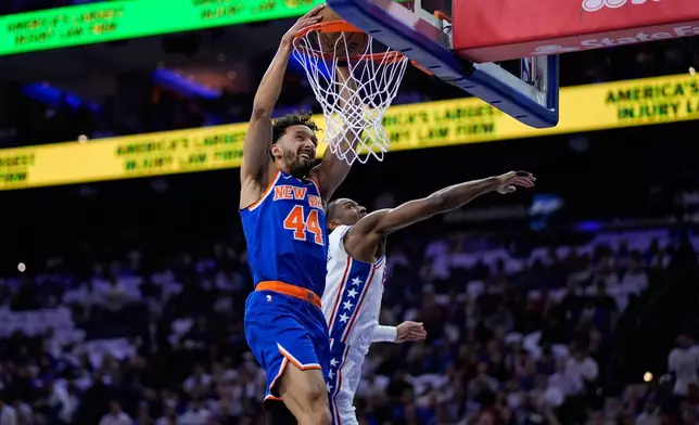 New York Knicks' Landry Shamet, left, dunks past Philadelphia 76ers' Tyrese Maxey during the first half of Game 3 in a second-round NBA basketball playoff series Friday, May 8, 2026, in Philadelphia. (AP Photo/Matt Slocum)