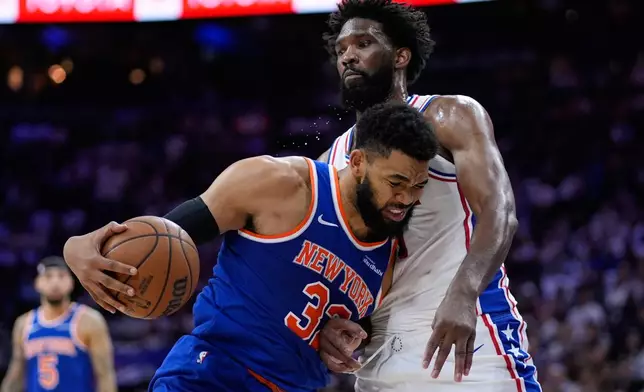 New York Knicks' Karl-Anthony Towns, left, tries to get past Philadelphia 76ers' Joel Embiid during the first half of Game 3 in a second-round NBA basketball playoff series Friday, May 8, 2026, in Philadelphia. (AP Photo/Matt Slocum)