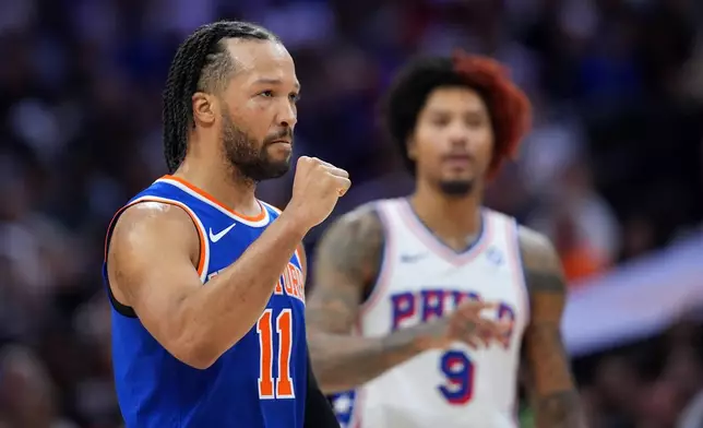New York Knicks' Jalen Brunson, left, reacts past Philadelphia 76ers' Kelly Oubre Jr. during the first half of Game 3 in a second-round NBA basketball playoff series Friday, May 8, 2026, in Philadelphia. (AP Photo/Matt Slocum)