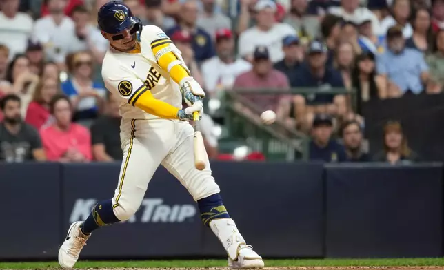 Milwaukee Brewers' William Contreras hits a two-run double during the fifth inning of a baseball game against the St. Louis Cardinals, Tuesday, May 26, 2026, in Milwaukee. (AP Photo/Aaron Gash)