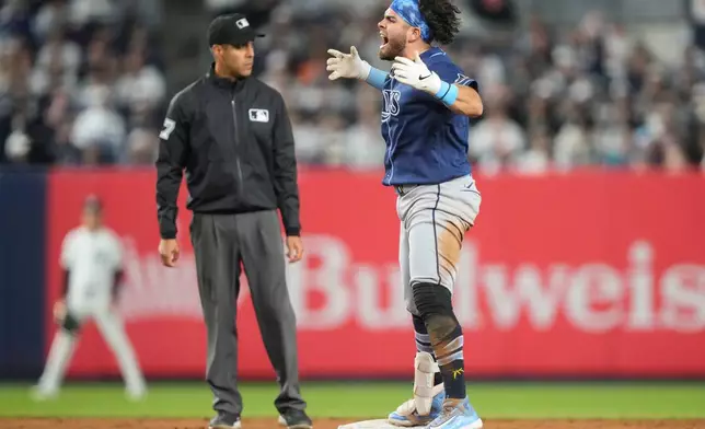 Tampa Bay Rays' Jonathan Aranda, right, reacts after hitting an RBI double during the eighth inning of a baseball game against the New York Yankees, Friday, May 22, 2026, in New York. (AP Photo/Yuki Iwamura)