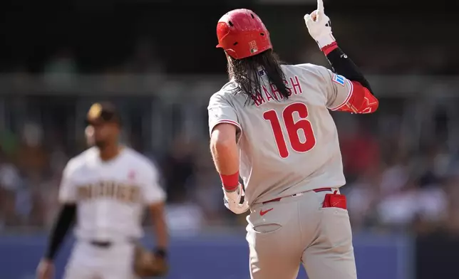 Philadelphia Phillies' Brandon Marsh celebrates after hitting a two-run home run during the seventh inning of a baseball game against the San Diego Padres Monday, May 25, 2026, in San Diego. (AP Photo/Gregory Bull)