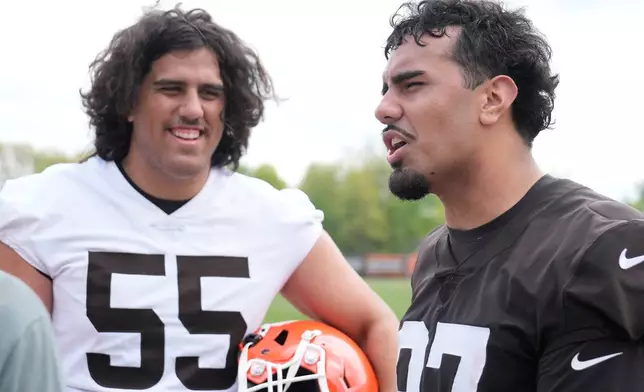 Cleveland Browns tackle Spencer Fano (55) and his brother, defensive end Logan Fano, right, talk after the NFL football team's rookie minicamp, Friday, May 8, 2026, in Berea, Ohio. (AP Photo/Sue Ogrocki)