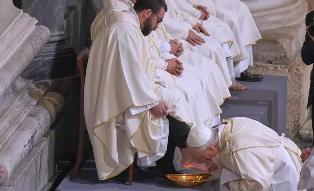 FILE - Pope Leo XIV washes and kisses the feet of 12 Roman priests during the Missa in Caena Domini, the Mass of the Lord's Supper, on Catholic Holy Thursday in St. John Lateran Basilica in Rome, Thursday, April 2, 2026. (AP Photo/Andrew Medichini, File)