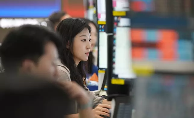 A dealer watches computer monitors at a dealing room of Hana Bank in Seoul, South Korea, Friday, May 8, 2026. (AP Photo/Lee Jin-man)