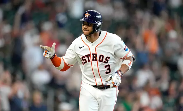 Houston Astros' Jeremy Pena points to the dugout after hitting a two-run home run off Milwaukee Brewers starting pitcher Brandon Sproat during the second inning of a baseball game, Saturday, May 30, 2026, in Houston. (AP Photo/Karen Warren)