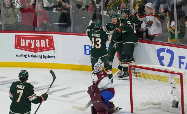 Minnesota Wild left wing Kirill Kaprizov (97) celebrates with teammates after scoring during the first period of Game 3 of an NHL Stanley Cup hockey second-round playoff series against the Colorado Avalanche, Saturday, May 9, 2026, in St. Paul, Minn. (AP Photo/Abbie Parr)