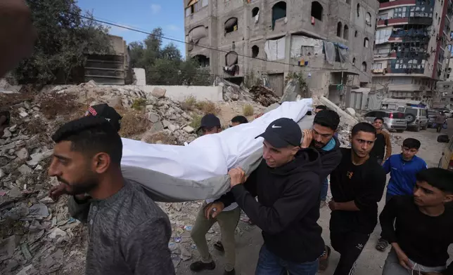 Palestinians carry the body of a person killed in Israeli airstrikes Friday targeting Izz al-Din al-Haddad, the leader of Hamas’ Qassam Brigades, during a funeral outside Shifa Hospital in Gaza City, Saturday, May 16, 2026. (AP Photo/Jehad Alshrafi)