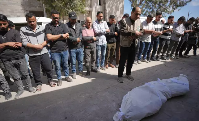 Palestinians pray over the body of a person killed in Israeli airstrikes Friday targeting Izz al-Din al-Haddad, the leader of Hamas’ Qassam Brigades, during a funeral outside Shifa Hospital in Gaza City, Saturday, May 16, 2026. (AP Photo/Jehad Alshrafi)