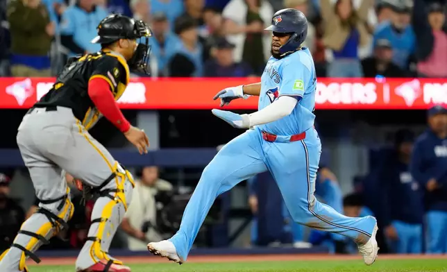 Toronto Blue Jays first baseman Vladimir Guerrero Jr. (27) scores on a Ernie Clement single during fourth inning of a baseball game against the Pittsburgh Pirates in Toronto on Sunday, May 24, 2026. (Frank Gunn /The Canadian Press via AP)