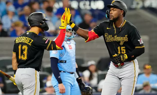 Pittsburgh Pirates Oneil Cruz (15) celebrates his home run with teammate Endy Rodríguez (13) during the econd inning of a baseball game against the Toronto Blue Jays in Toronto on Sunday, May 24, 2026. (Frank Gunn/The Canadian Press via AP)