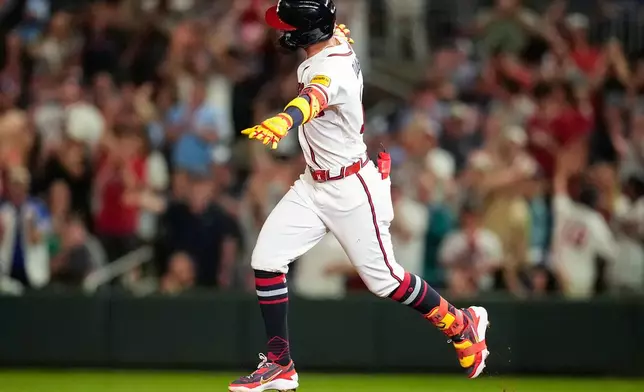 Atlanta Braves' Mauricio Dubón celebrates his two-run home run against the Chicago Cubs in the eighth inning of a baseball game, Wednesday, May 13, 2026, in Atlanta. (AP Photo/Mike Stewart)