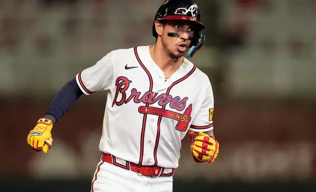 Atlanta Braves' Mauricio Dubón celebrates his two-run home run against the Chicago Cubs in the eighth inning of a baseball game, Wednesday, May 13, 2026, in Atlanta. (AP Photo/Mike Stewart)
