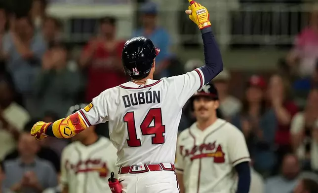 Atlanta Braves' Mauricio Dubón celebrates his two-run home run against the Chicago Cubs in the eighth inning of a baseball game, Wednesday, May 13, 2026, in Atlanta. (AP Photo/Mike Stewart)