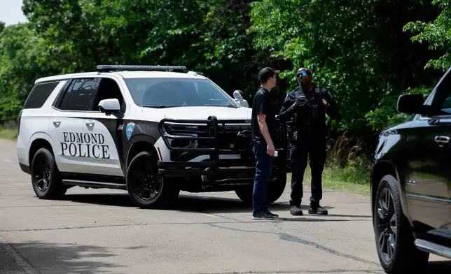 Officials block the entrance to Scissortail Campground at Arcadia Lake, Monday, May 4, 2026, in Edmond, Okla., after a shooting on Sunday evening. (AP Photo/Alonzo Adams)